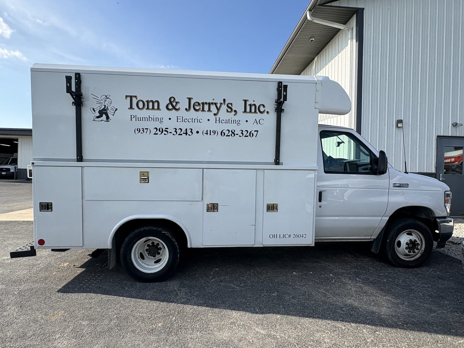 A Tom & Jerry's service truck seen from the side, with the Ohio license number lettered on the door